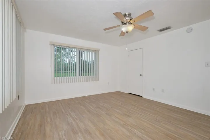 Spare room featuring ceiling fan and light hardwood / wood-style floors