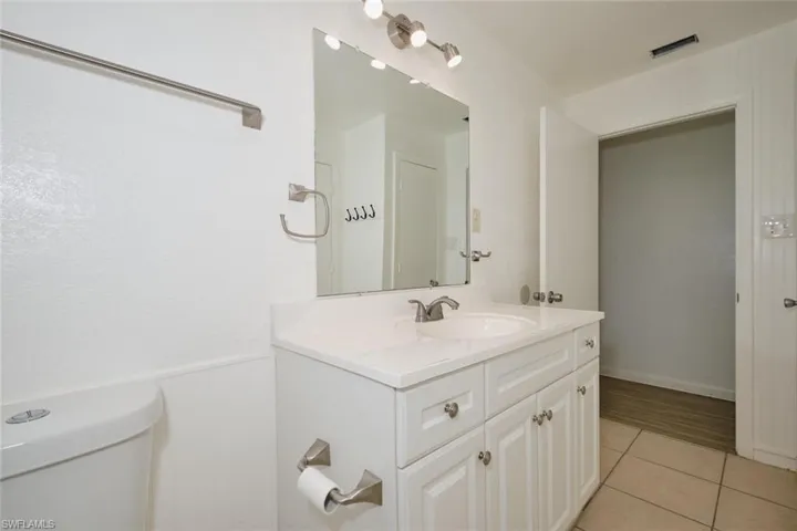 Bathroom with tile patterned flooring, vanity, and toilet