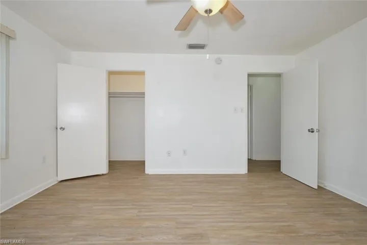 Unfurnished bedroom featuring ceiling fan, a closet, and light hardwood / wood-style flooring