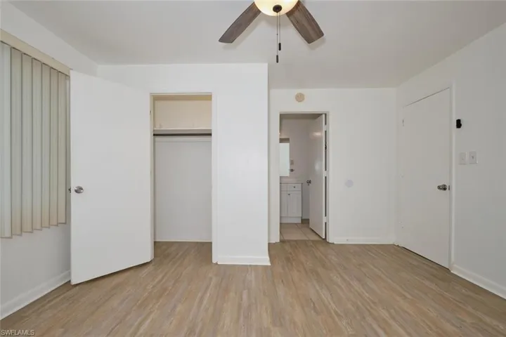 Unfurnished bedroom with light hardwood / wood-style flooring, a closet, and ceiling fan