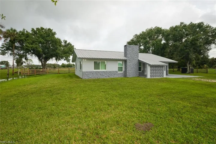 Ranch-style home featuring a garage and a front yard