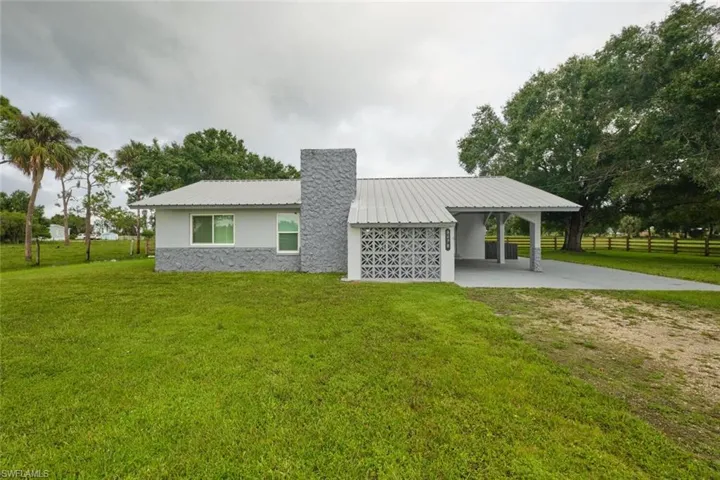 Rear view of property featuring a lawn