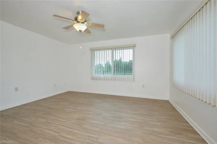 Empty room with light hardwood / wood-style flooring and ceiling fan