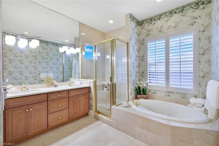 Has dual vanity sinks, separate walk-in shower and spa tub