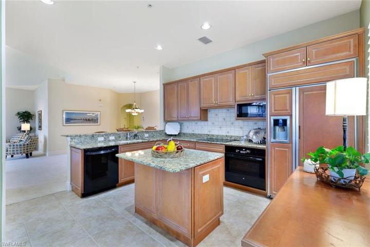 Kitchen has excellent storage with center island with breakfast bar for two, there is also a raised bar area between the dining room and the kitchen.