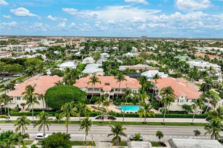 Front aerial view from 3rd St. South. Showing main front gate (which is secure). There is a privacy hedge that runs the length of the property on the West side.