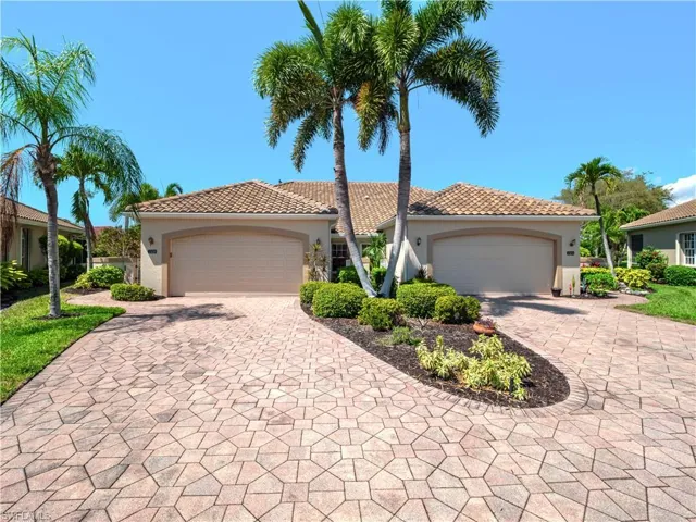 Mediterranean / spanish-style home with stucco siding, a tile roof, and driveway