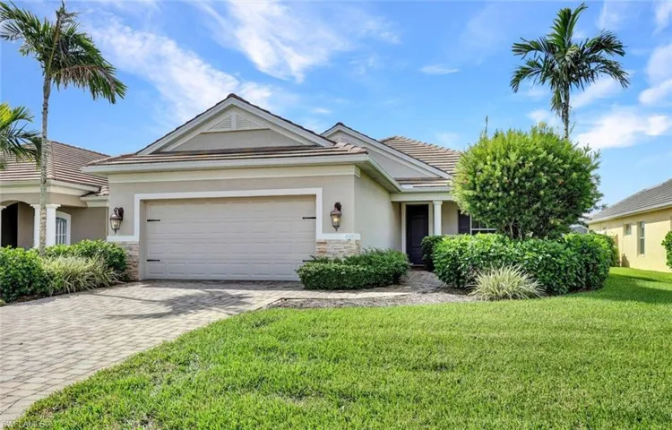 View of front of house featuring a front lawn and a garage
