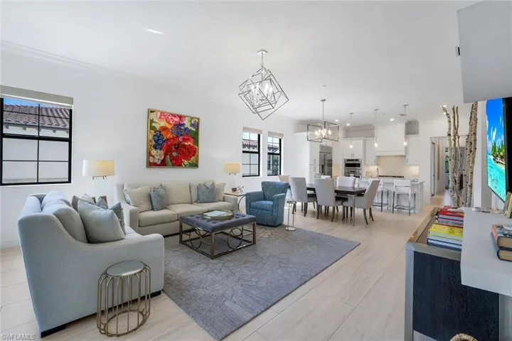 Living area with crown molding and a chandelier