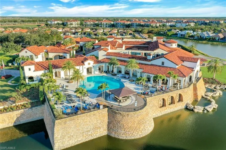 Drone / aerial view of a pool area and a large body of water