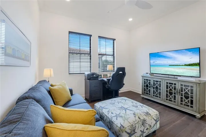 Home office with dark wood-style floors, ornamental molding, recessed lighting, and ceiling fan