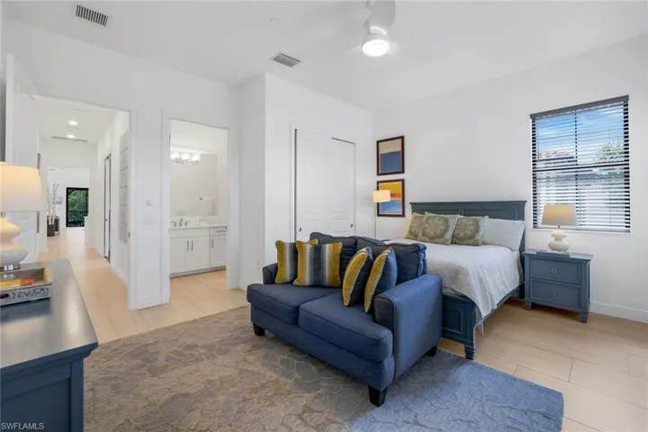 Bedroom with ceiling fan, a closet, and light wood-style floors