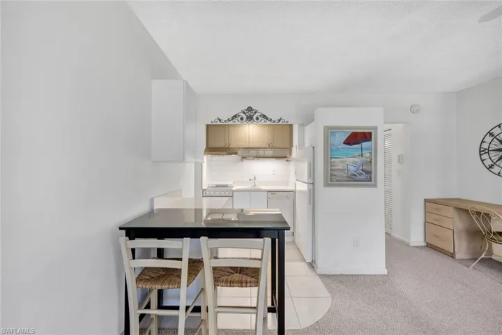 Carpeted dining area with sink