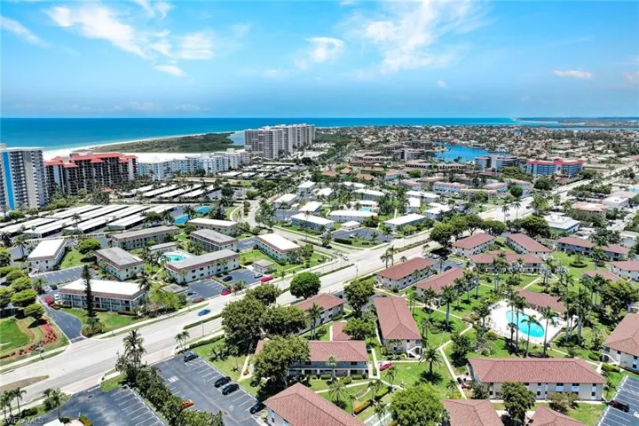 Birds eye view of property with a water view