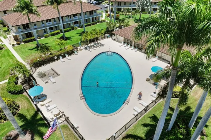 View of pool featuring a patio and a lawn