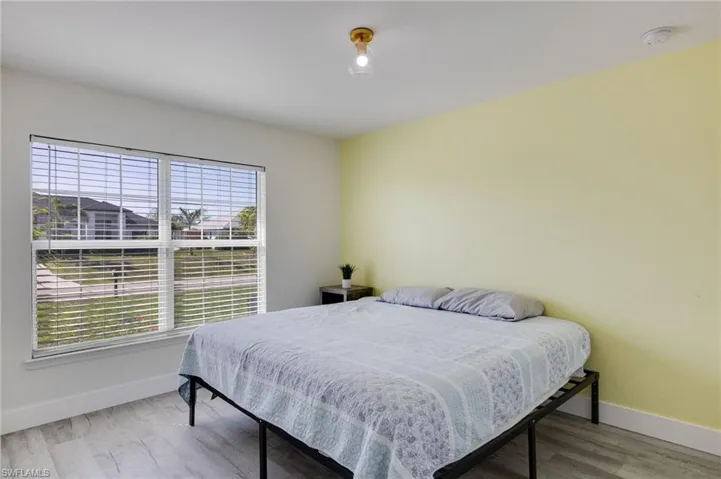 Bedroom with light wood finished floors and baseboards