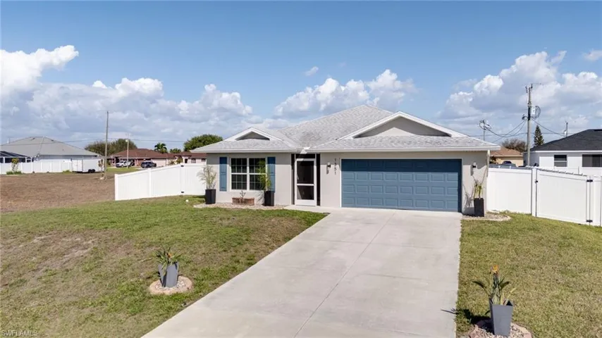 Single story home featuring a gate, a garage, driveway, and stucco siding