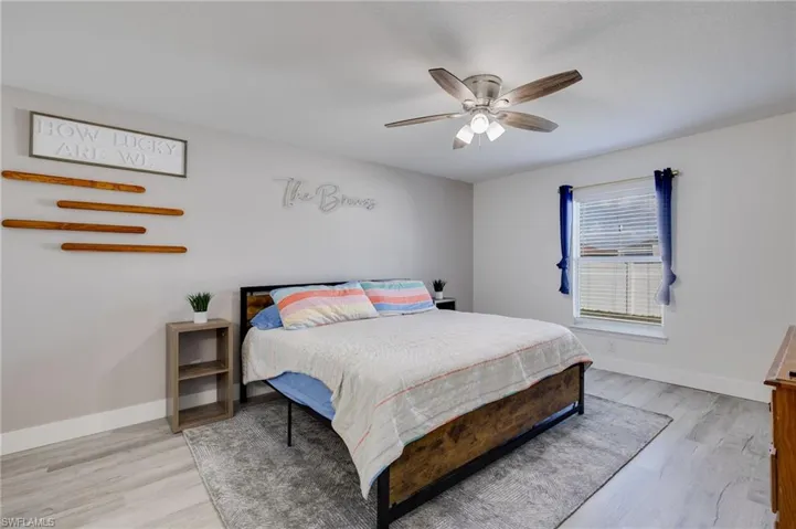 Bedroom with light wood finished floors and ceiling fan