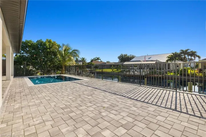 View of swimming pool featuring a patio area and a water view