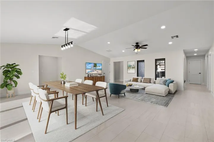 Dining space featuring ceiling fan and lofted ceiling