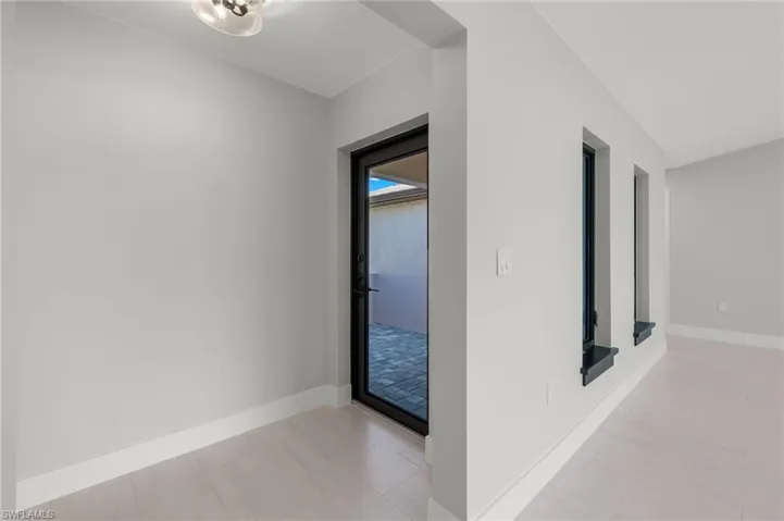 Hallway featuring light tile patterned floors