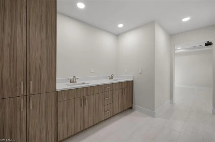 Bathroom with dual vanity and tile patterned flooring