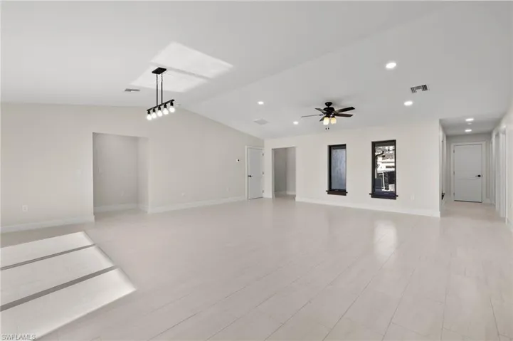 Unfurnished living room featuring ceiling fan