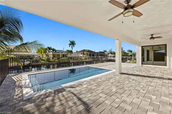 View of swimming pool with a patio and ceiling fan