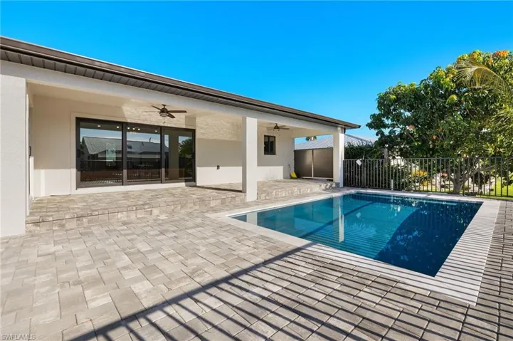 View of pool featuring ceiling fan and a patio area