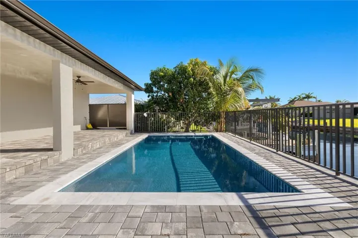 View of swimming pool with a patio and ceiling fan