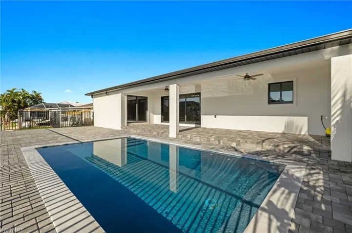 View of swimming pool with a patio area and ceiling fan