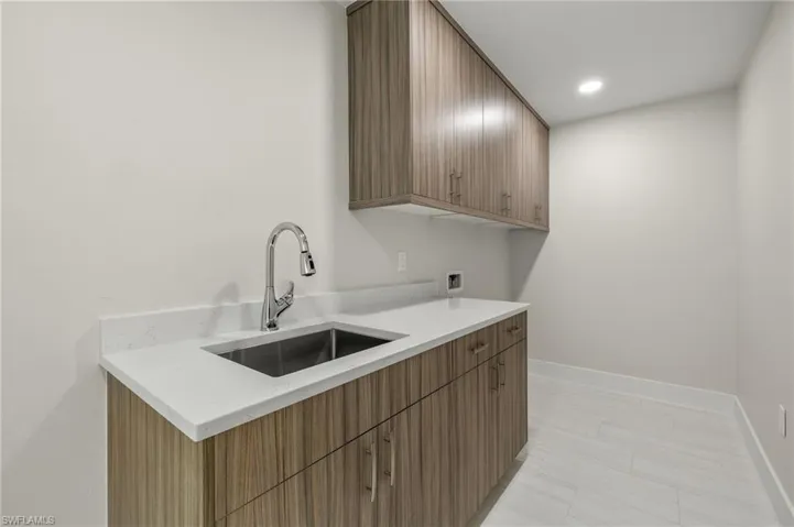 Kitchen with sink and light tile patterned flooring
