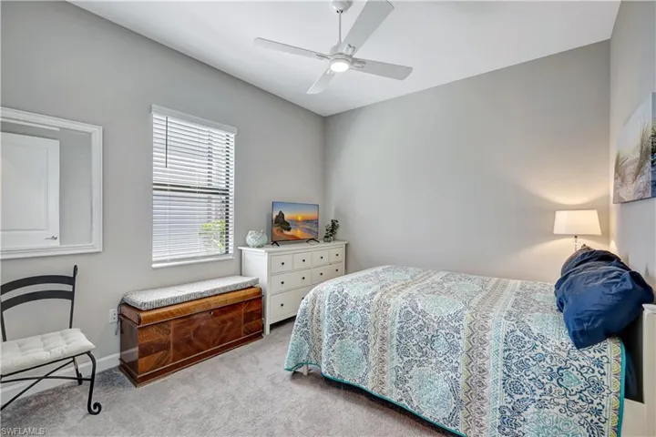 Bedroom featuring carpet flooring, a ceiling fan, and baseboards