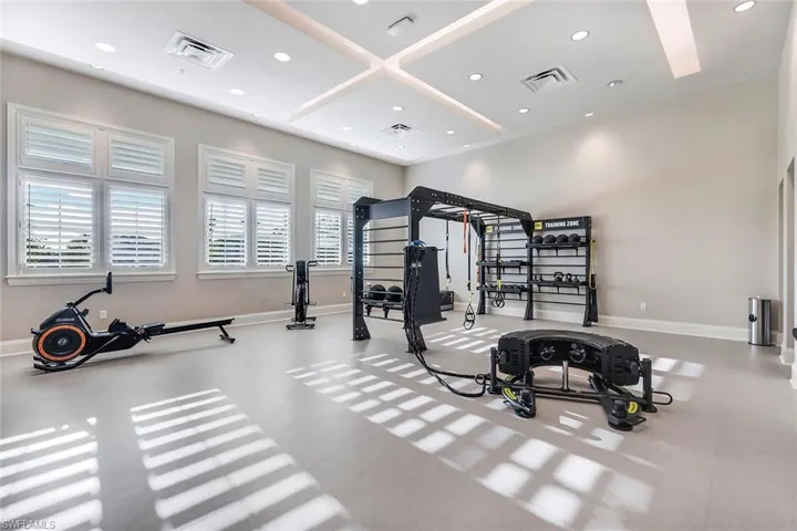 Exercise room with recessed lighting, baseboards, and coffered ceiling