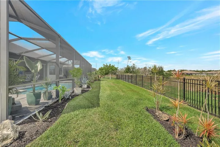 View of yard featuring glass enclosure