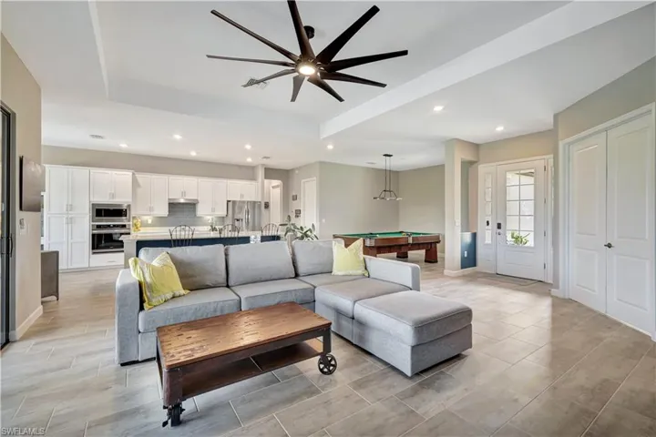 Living room featuring billiards, a ceiling fan, recessed lighting, and baseboards