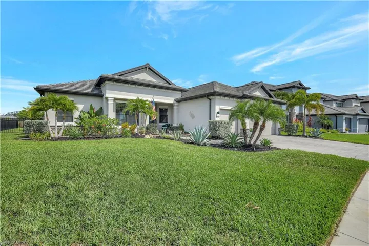 View of front of property featuring concrete driveway, stucco siding, and an attached garage