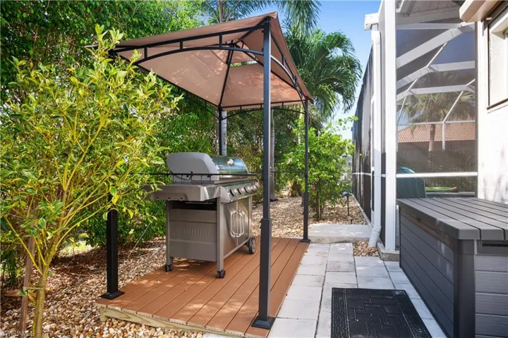 Wooden deck with a lanai, a patio area, grilling area, and a sunroom