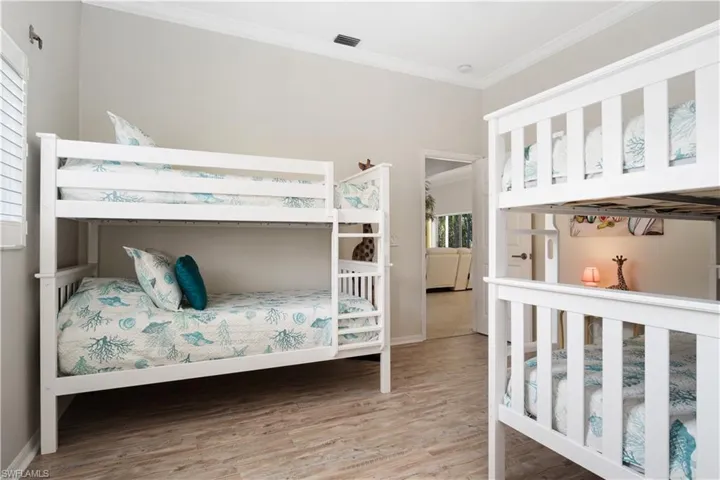 Bedroom featuring light wood-style floors and ornamental molding
