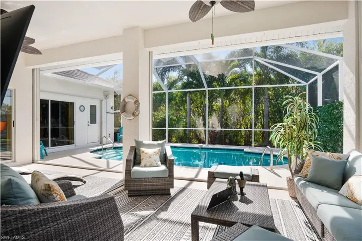 Outdoor pool with a ceiling fan, a sunroom, and a patio area