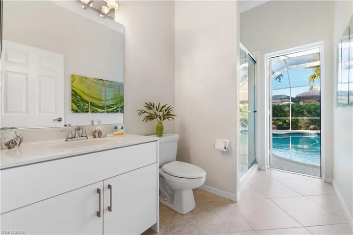 Bathroom with vanity, light tile patterned flooring, and a shower stall