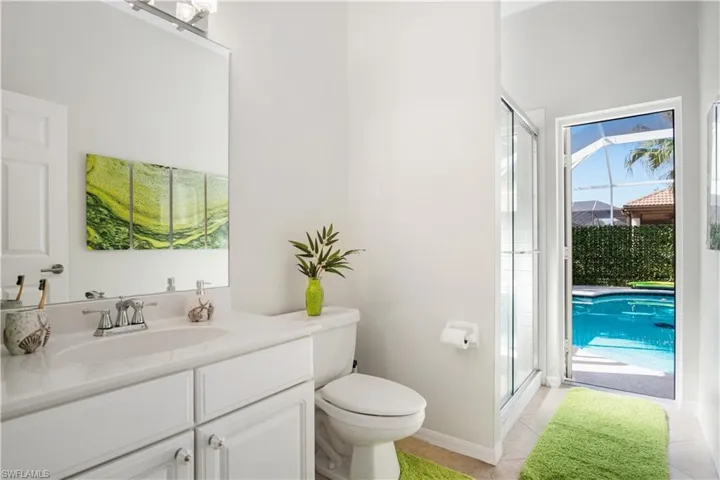 Full bathroom featuring a shower stall, vanity, and light tile patterned floors