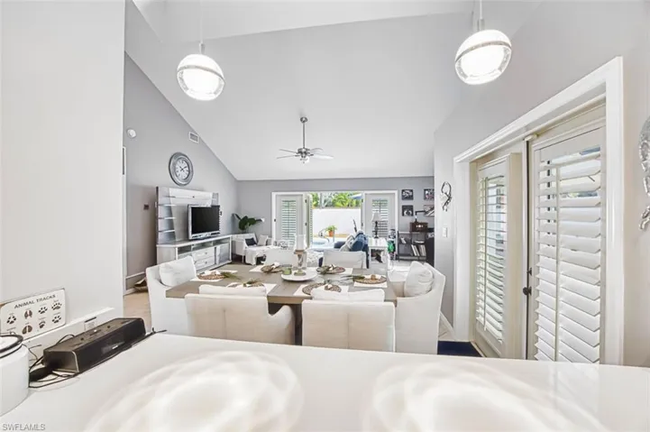 Dining space with vaulted ceiling and ceiling fan