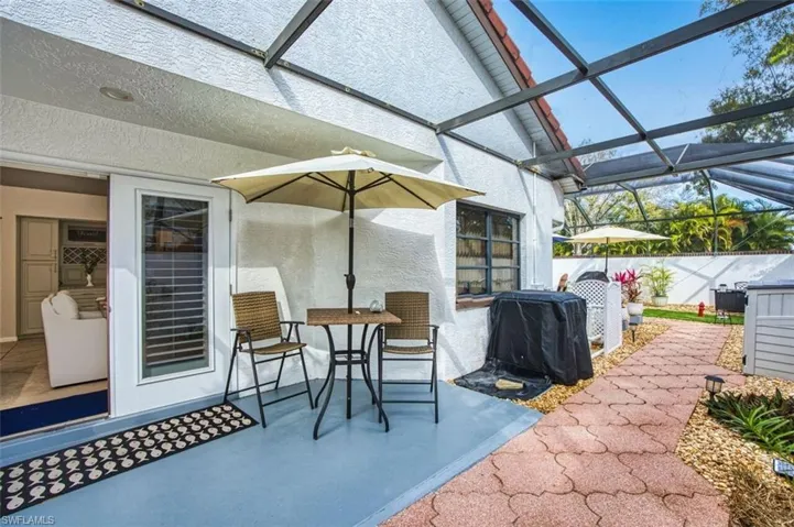 View of patio / terrace with glass enclosure, a sunroom, and grilling area