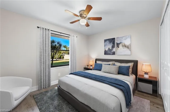 Bedroom with a closet, wood finished floors, and ceiling fan