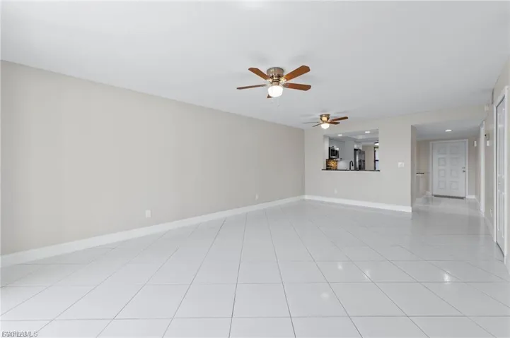 Unfurnished room featuring ceiling fan, light tile patterned floors, and recessed lighting