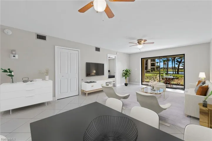 Living room with light tile patterned floors and ceiling fan