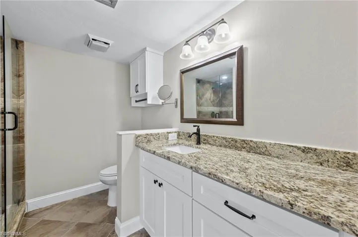 Full bath with vanity and a stall shower