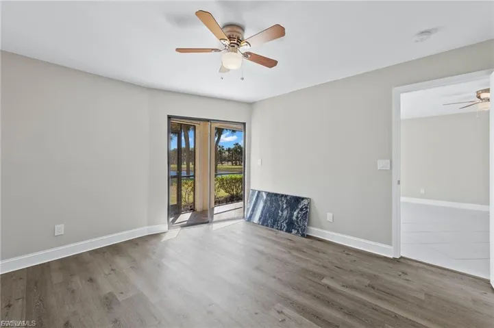 Unfurnished room with ceiling fan and wood finished floors