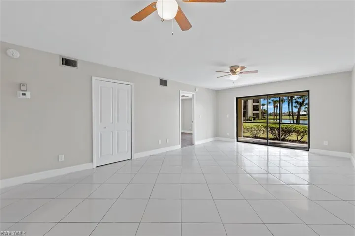 Spare room featuring ceiling fan and light tile patterned floors